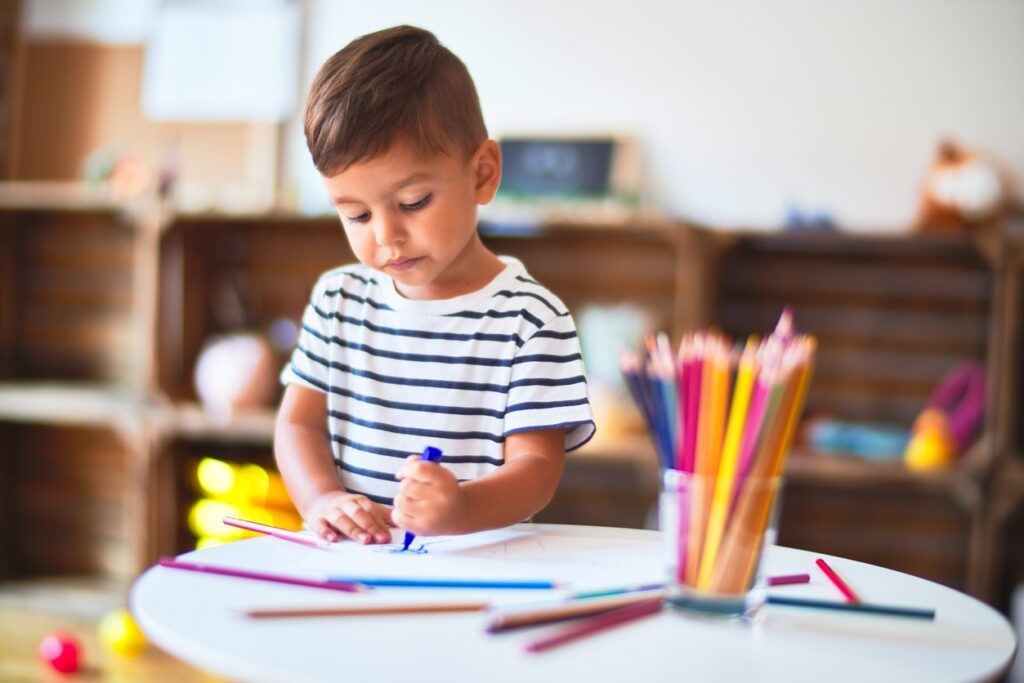 Beautiful-toddler-boy-drawing-cute-draw-using-colored-pencils-at-kindergarten-1185932018_1257x838